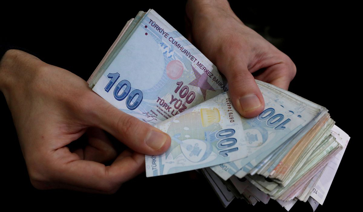 A merchant counts Turkish lira banknotes at the Grand Bazaar in Istanbul